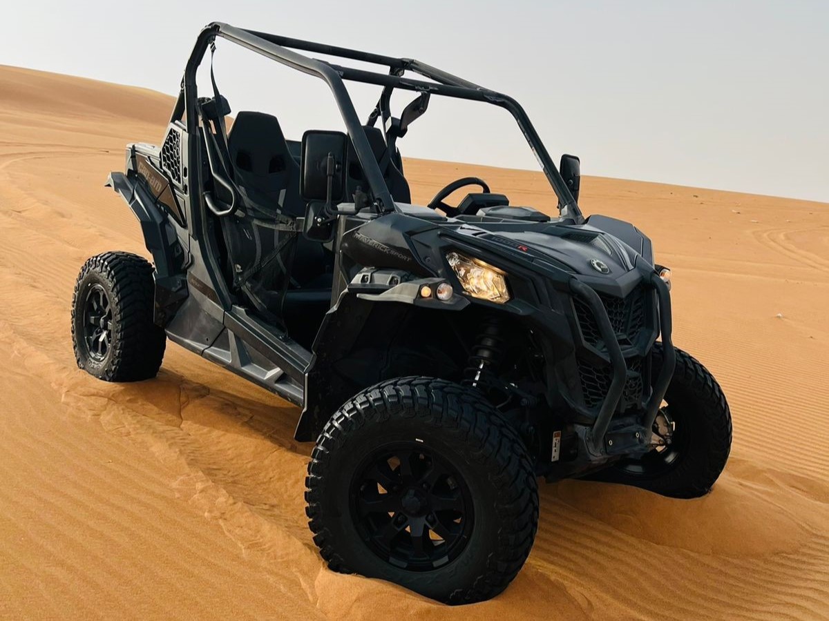 Buggy CanAm DS sport noir sur une dune de Dubaï , prêt à partir en tour avec ses 2 passagers